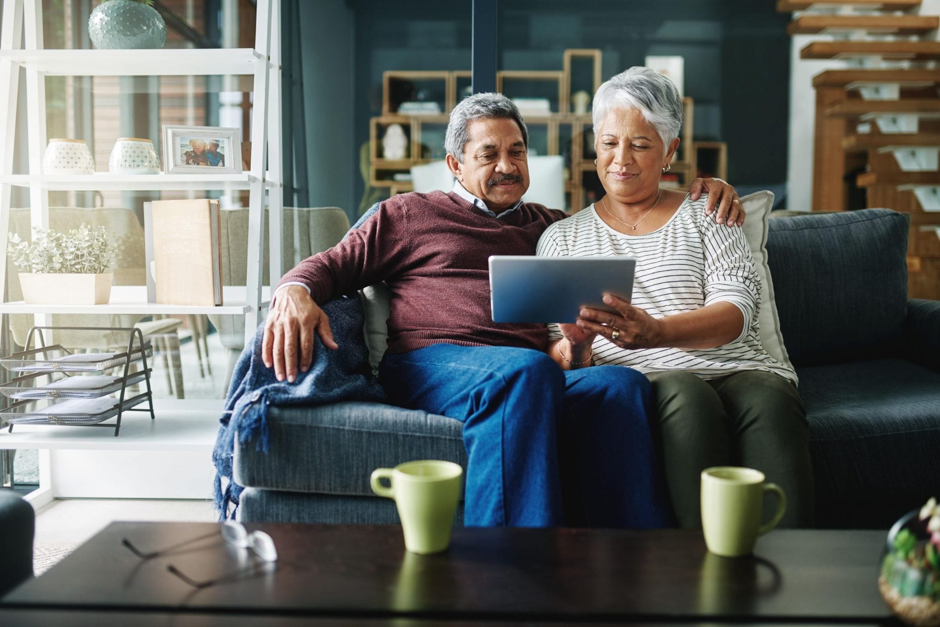 Elderly couple sitting together on couch