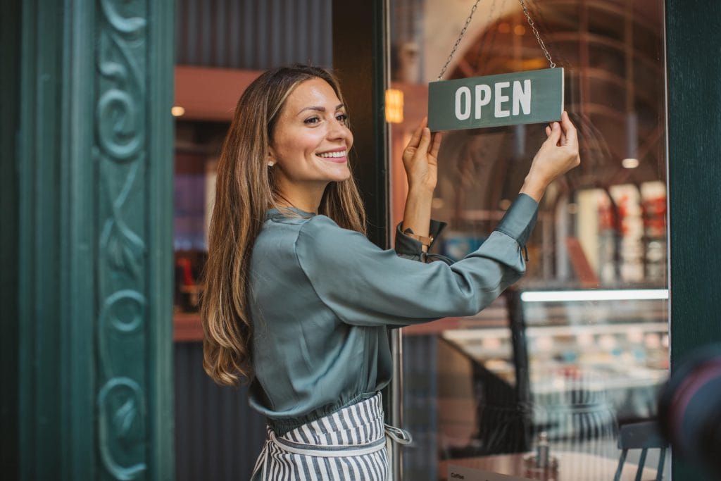 Business owner flipping her OPEN sign
