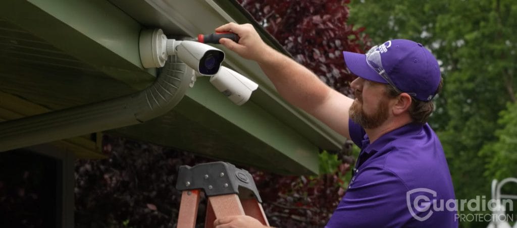Guardian Protection technician installing security camera at Animal Friends