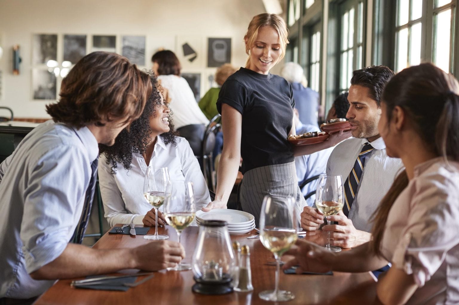 Waitress serving customers at restaurant