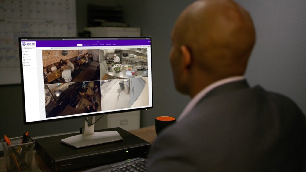 Small business owner checking in on his Guardian Protection security cameras' live feeds